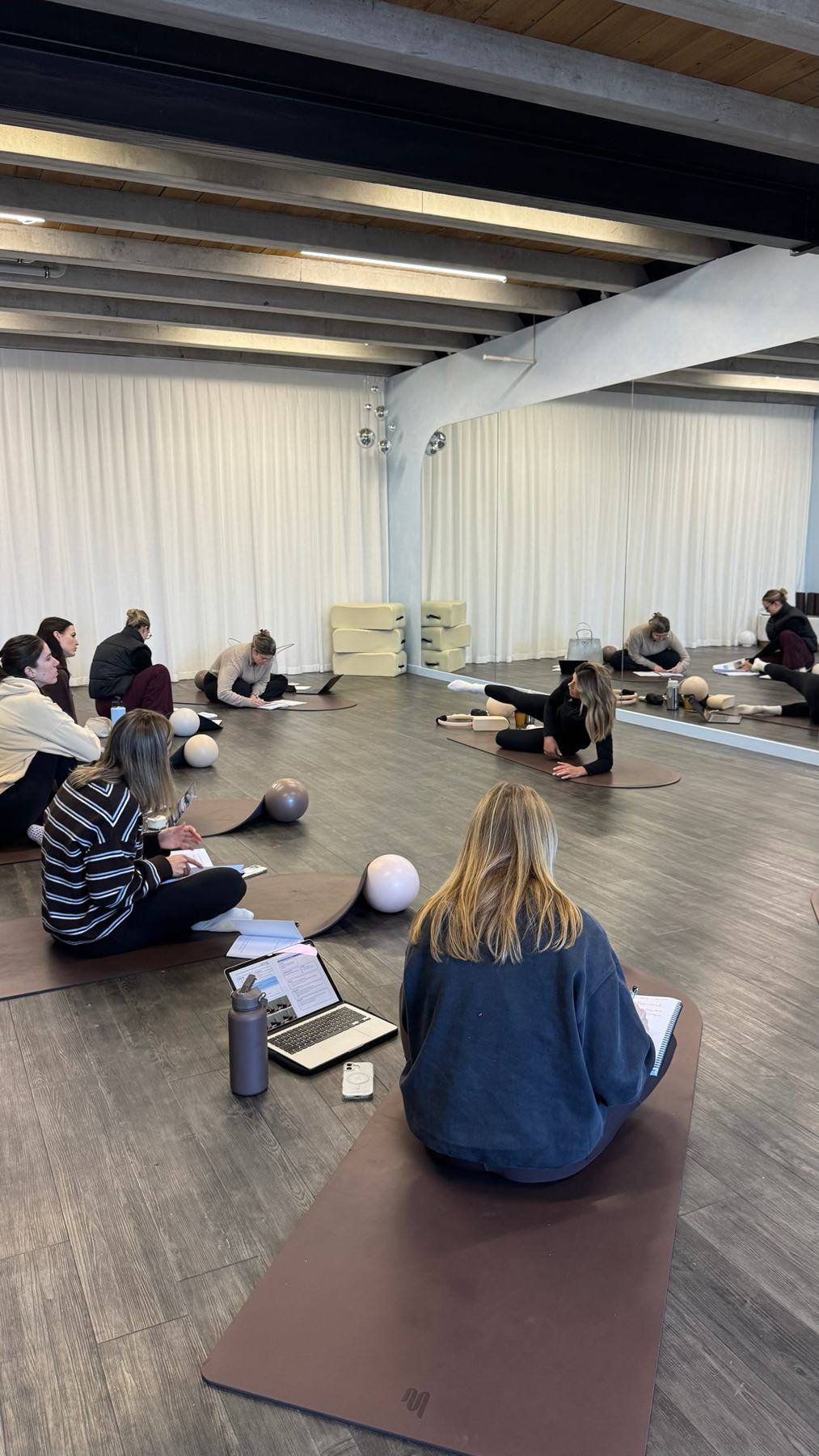 Students practising Mat Pilates on a Body Form Education practical day
