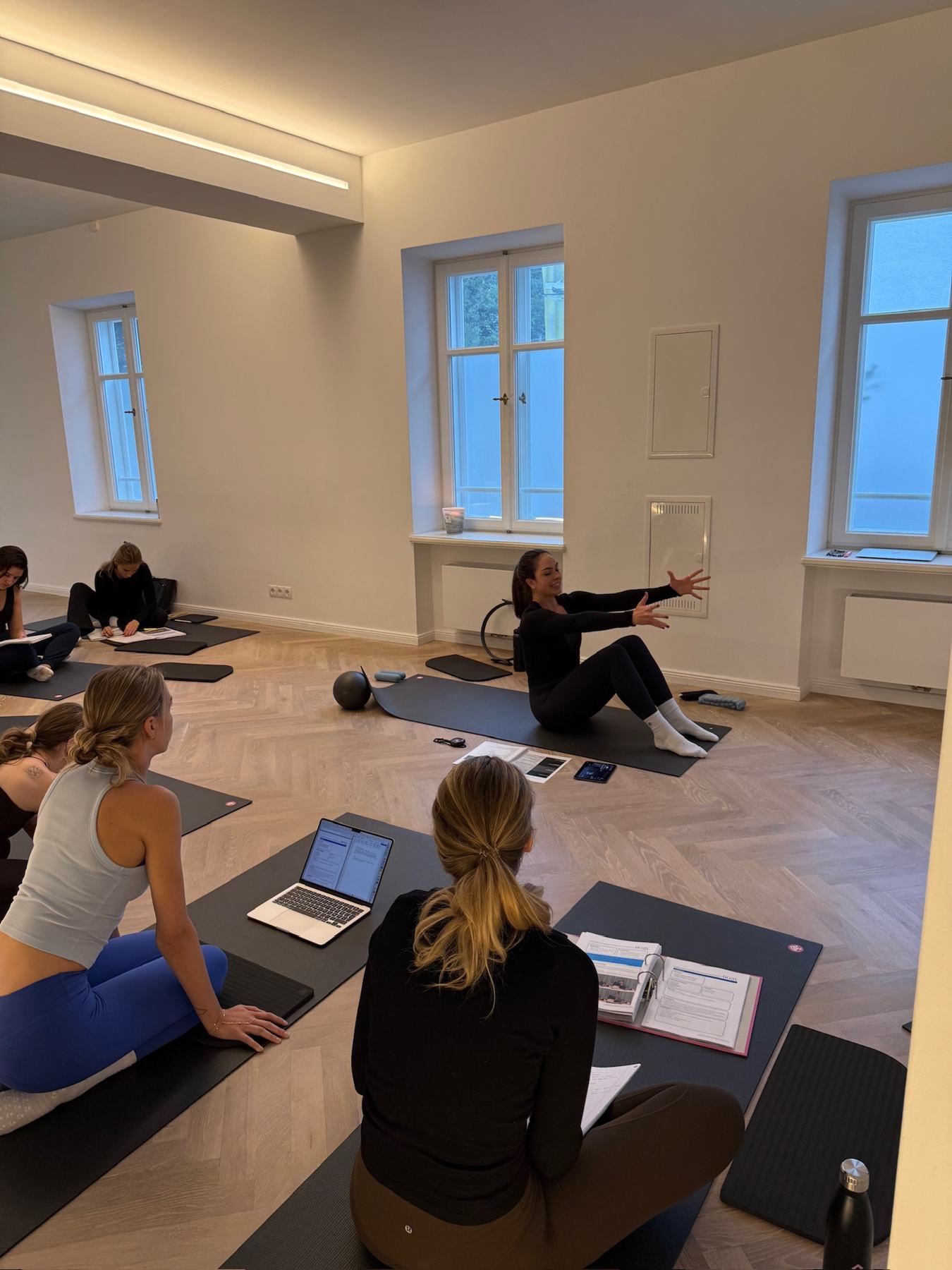 Students practising Mat Pilates on a Body Form Education practical day