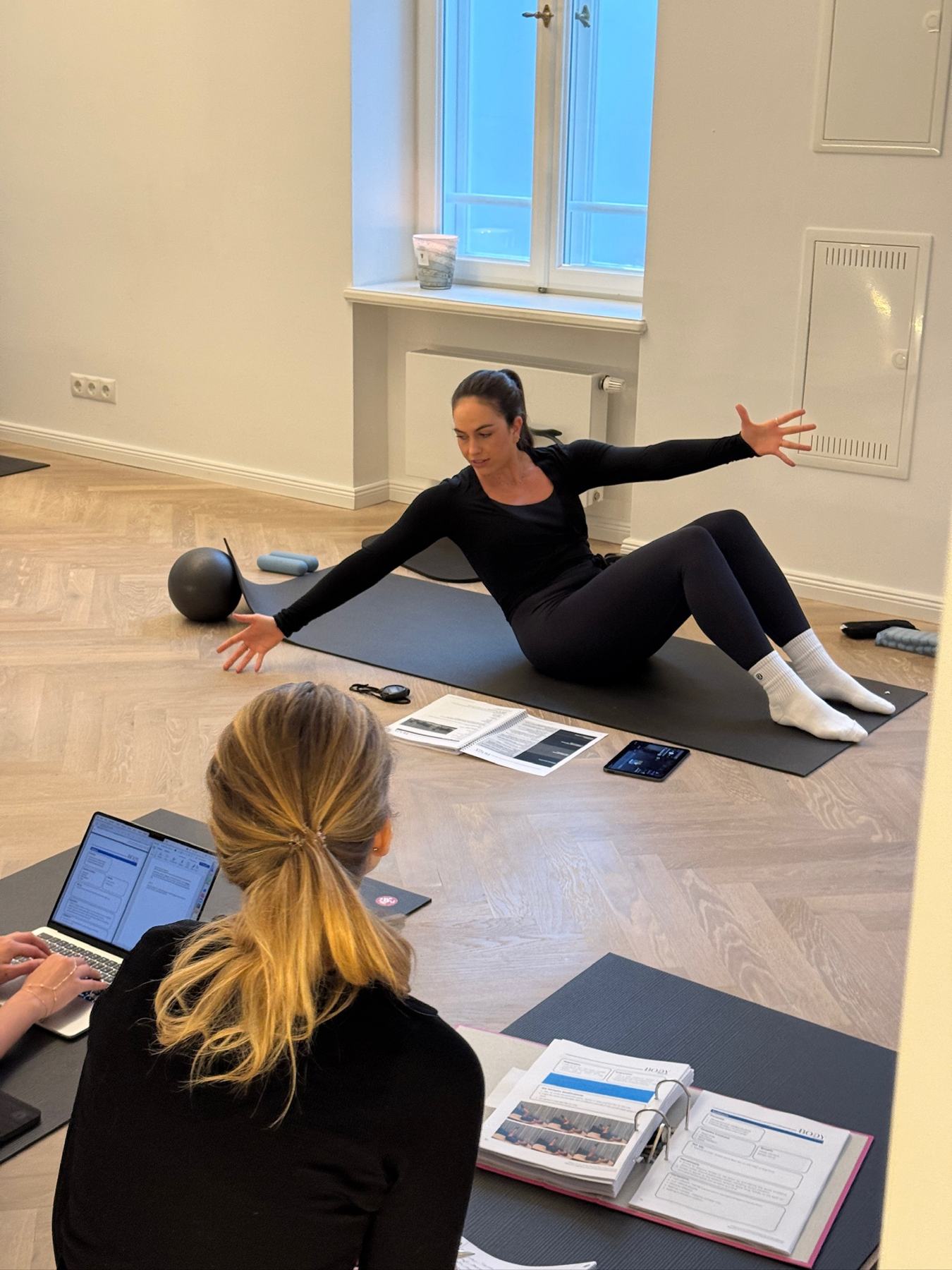 Students practising Mat Pilates on a Body Form Education practical day