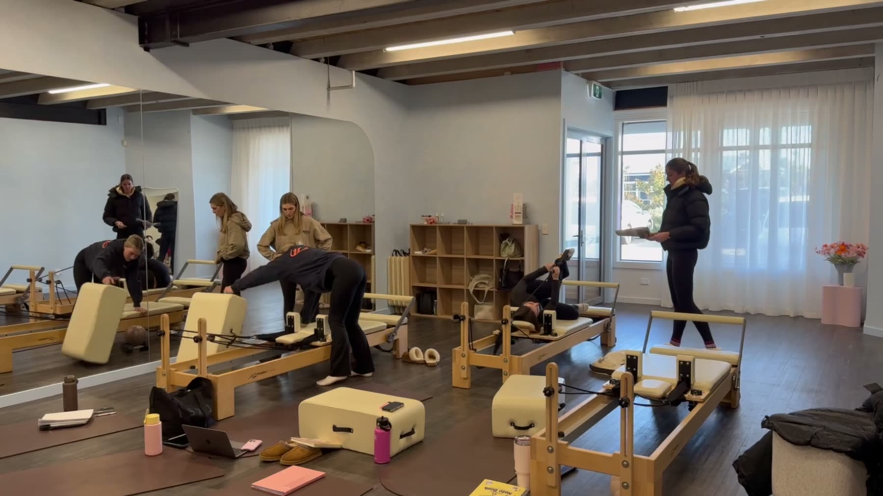 Students and trainer working on Reformers during a Body Form Education intake