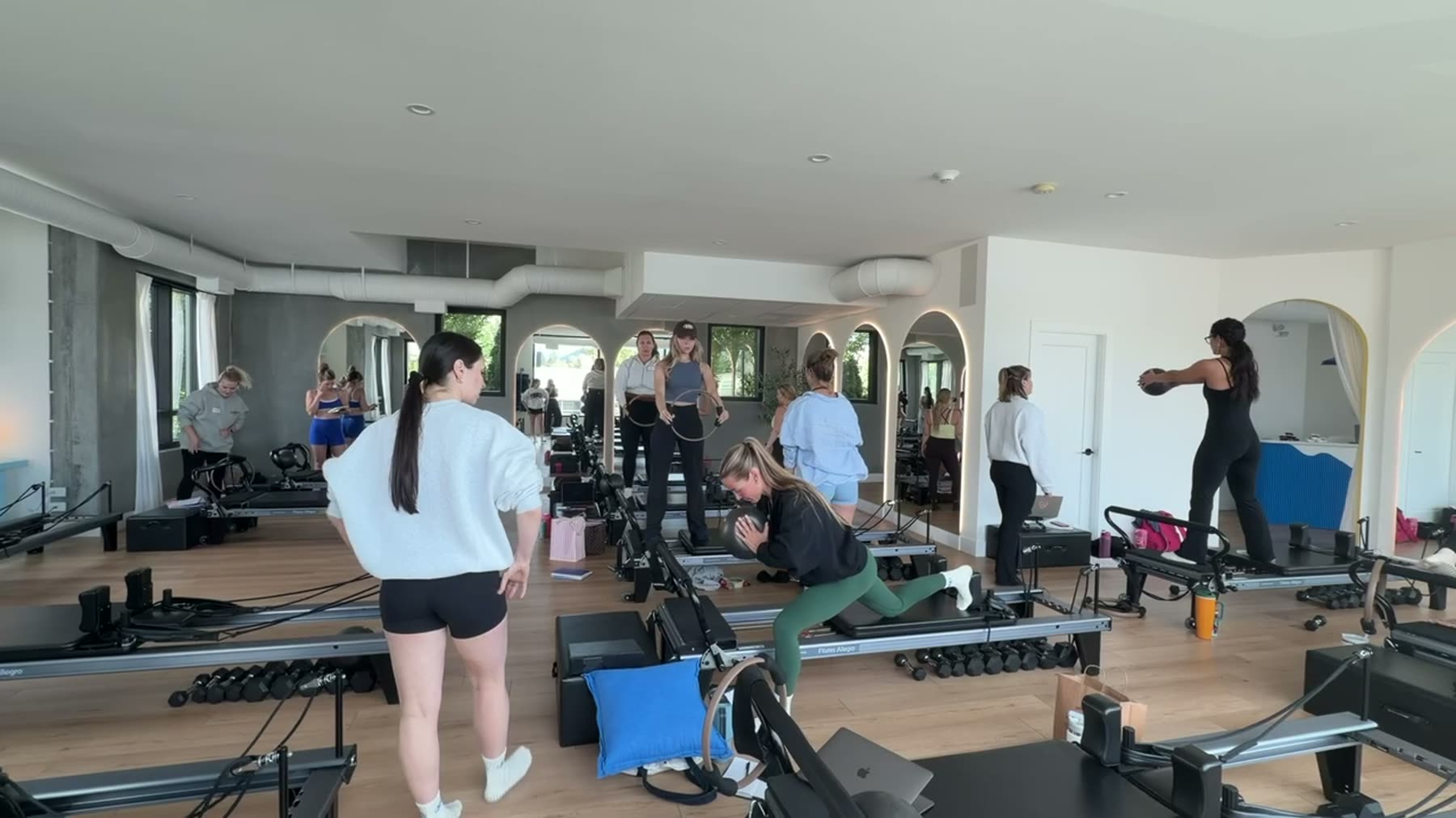 Students and trainer working on Reformers during a Body Form Education intake