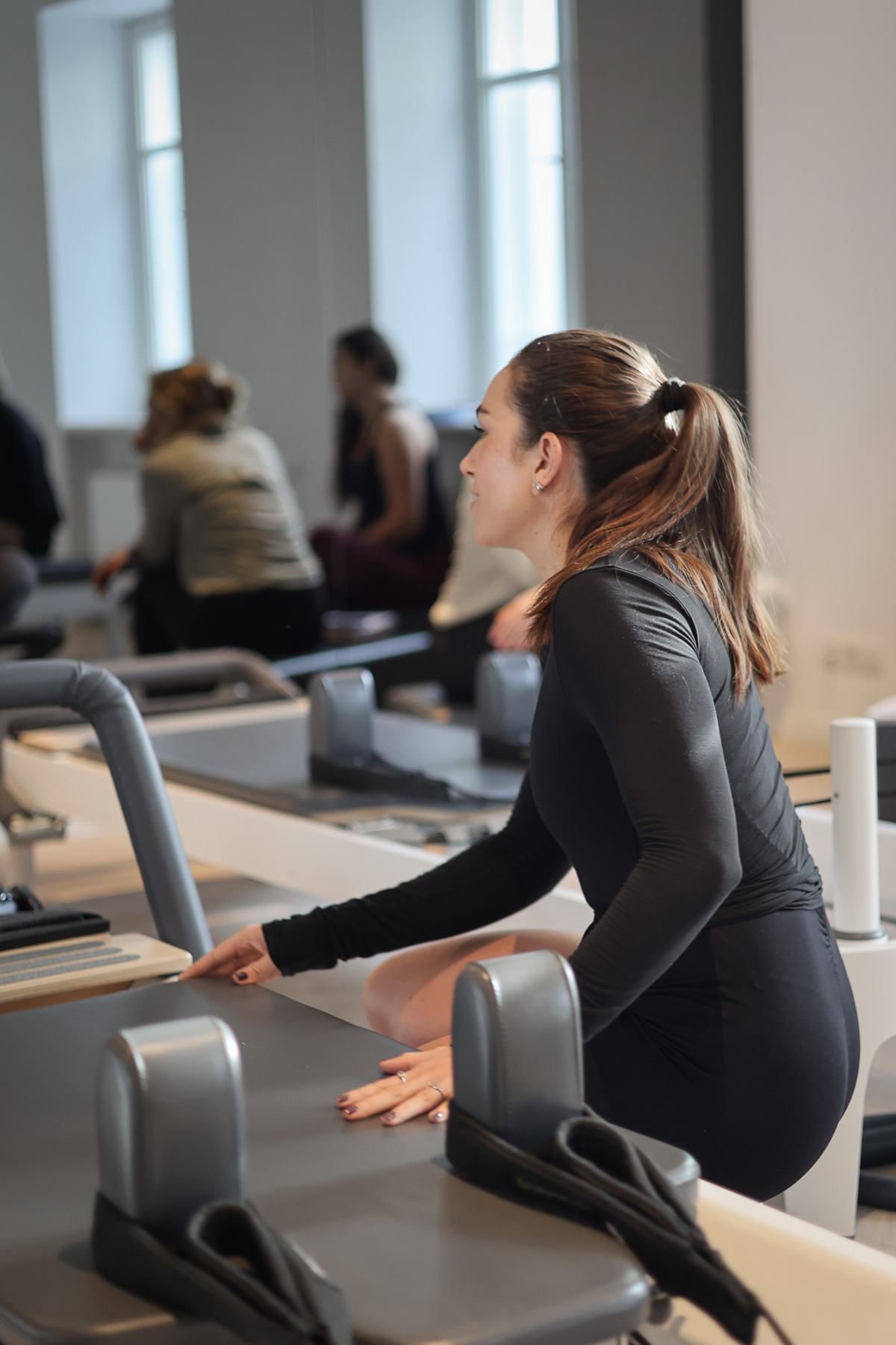 Students and trainer working on Reformers during a Body Form Education intake
