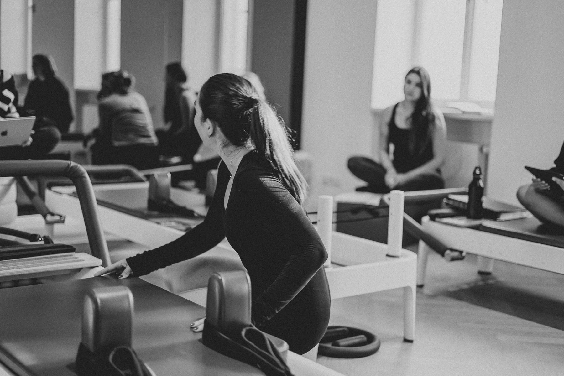 Students and trainer working on Reformers during a Body Form Education intake