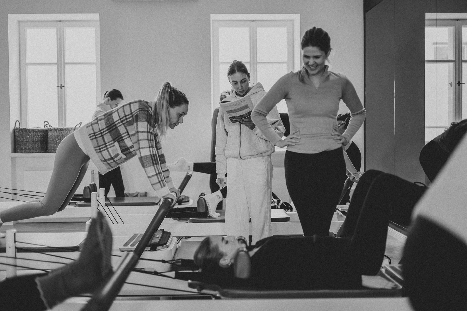 Students and trainer working on Reformers during a Body Form Education intake