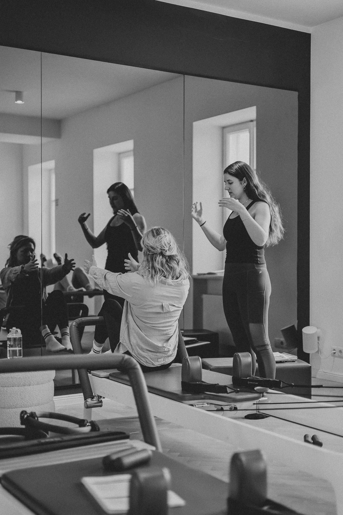 Students and trainer working on Reformers during a Body Form Education intake