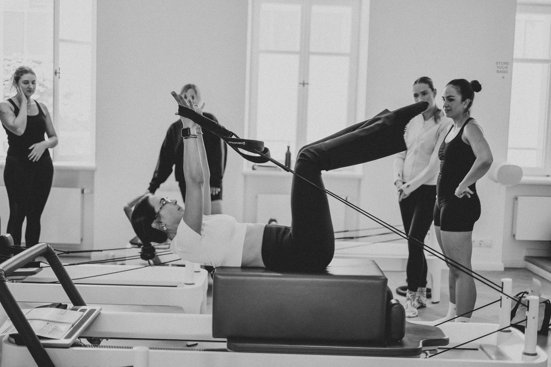 Students and trainer working on Reformers during a Body Form Education intake