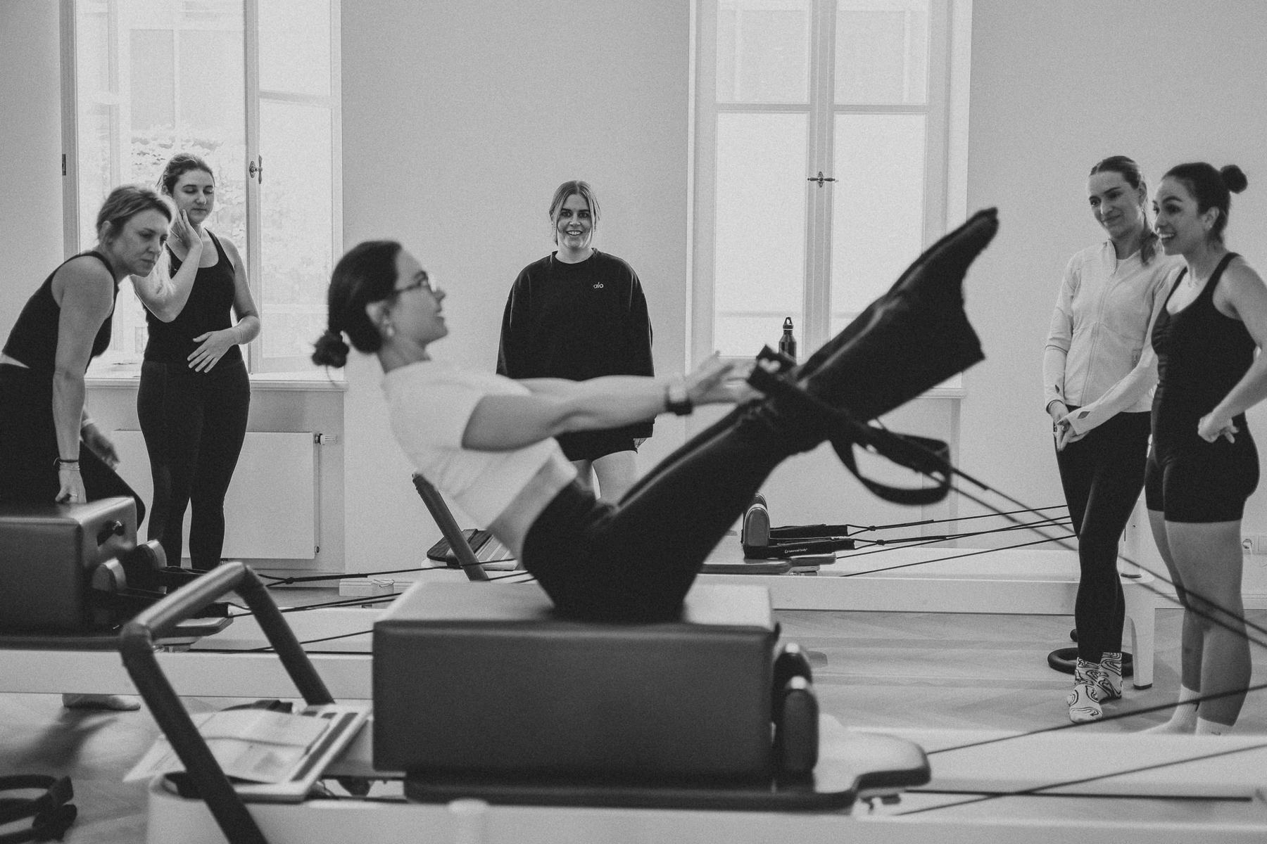 Students and trainer working on Reformers during a Body Form Education intake