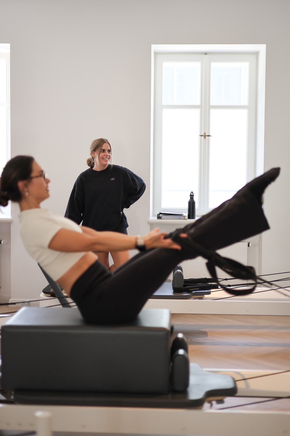 Students and trainer working on Reformers during a Body Form Education intake