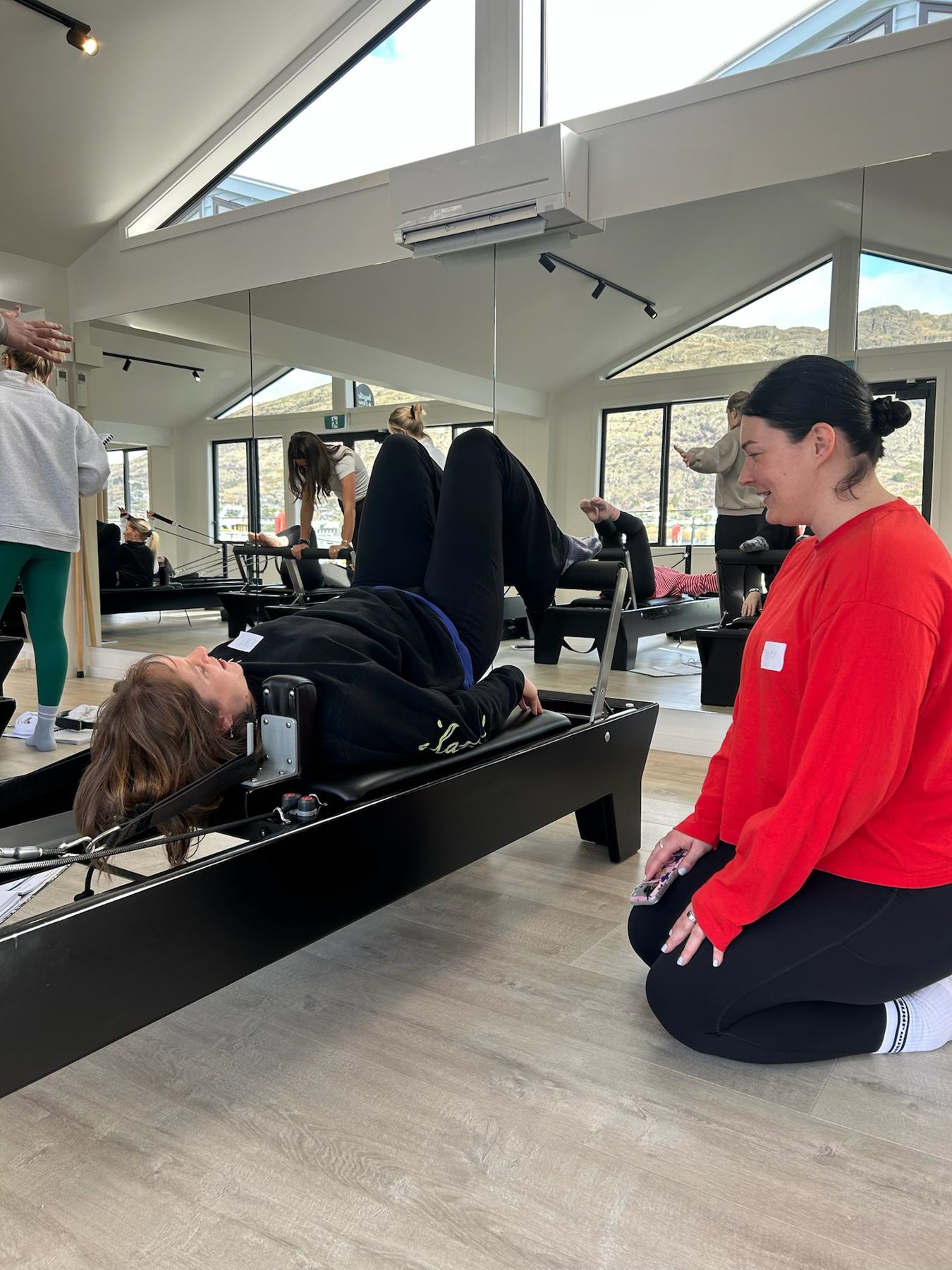 Students and trainer working on Reformers during a Body Form Education intake