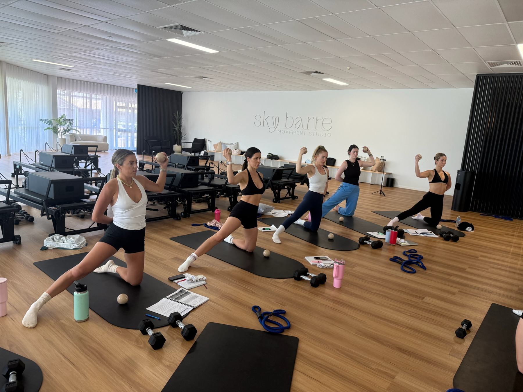 Students and trainer working on Reformers during a Body Form Education intake