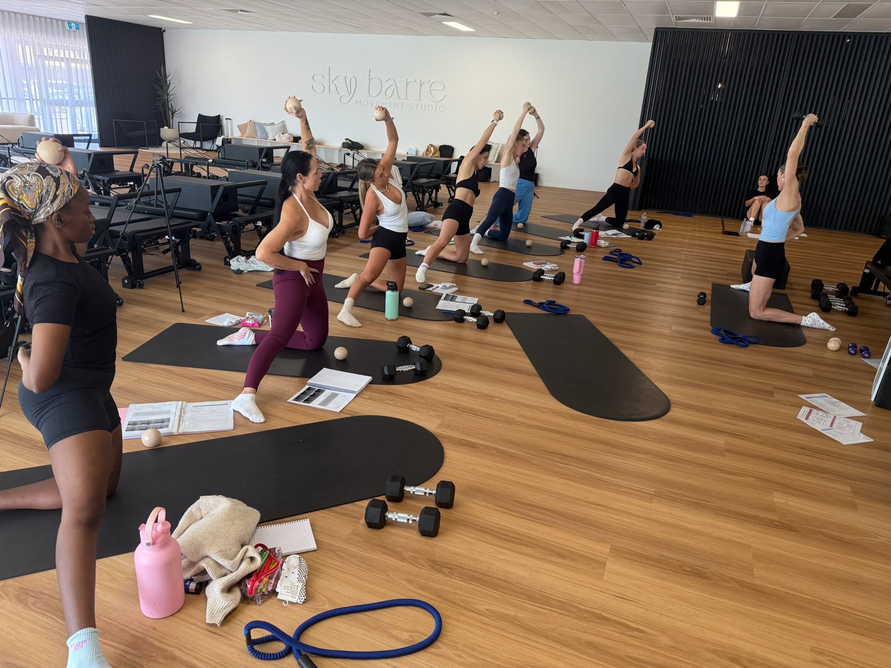 Students and trainer working on Reformers during a Body Form Education intake