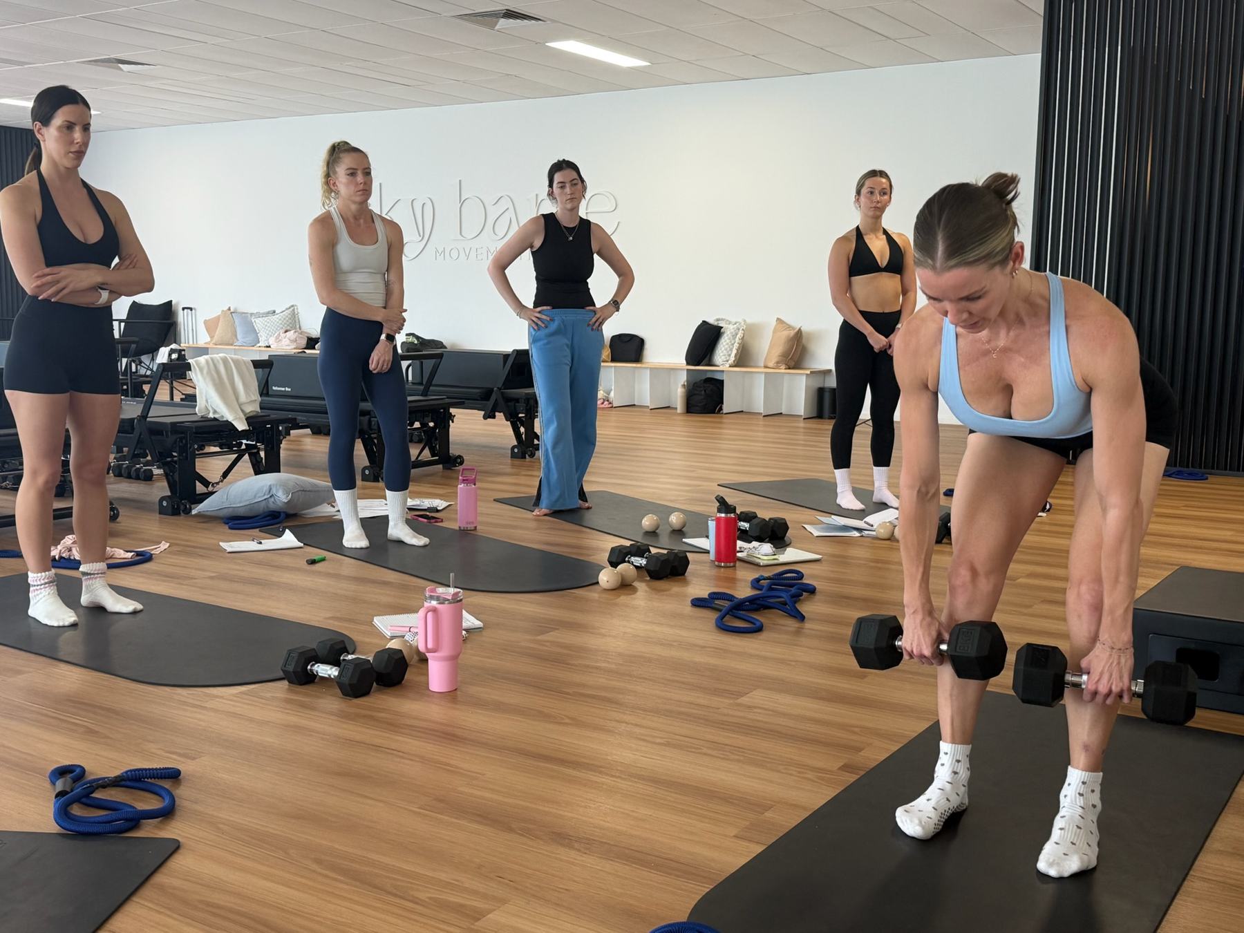 Students and trainer working on Reformers during a Body Form Education intake