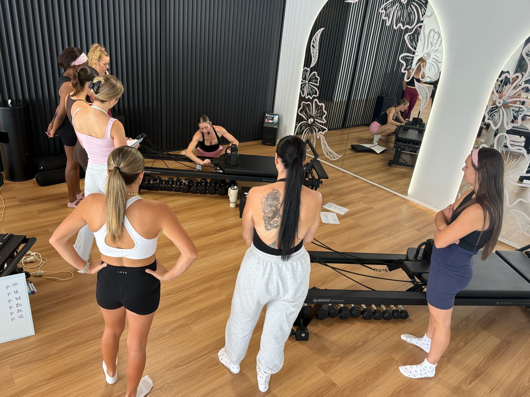 Students and trainer working on Reformers during a Body Form Education intake