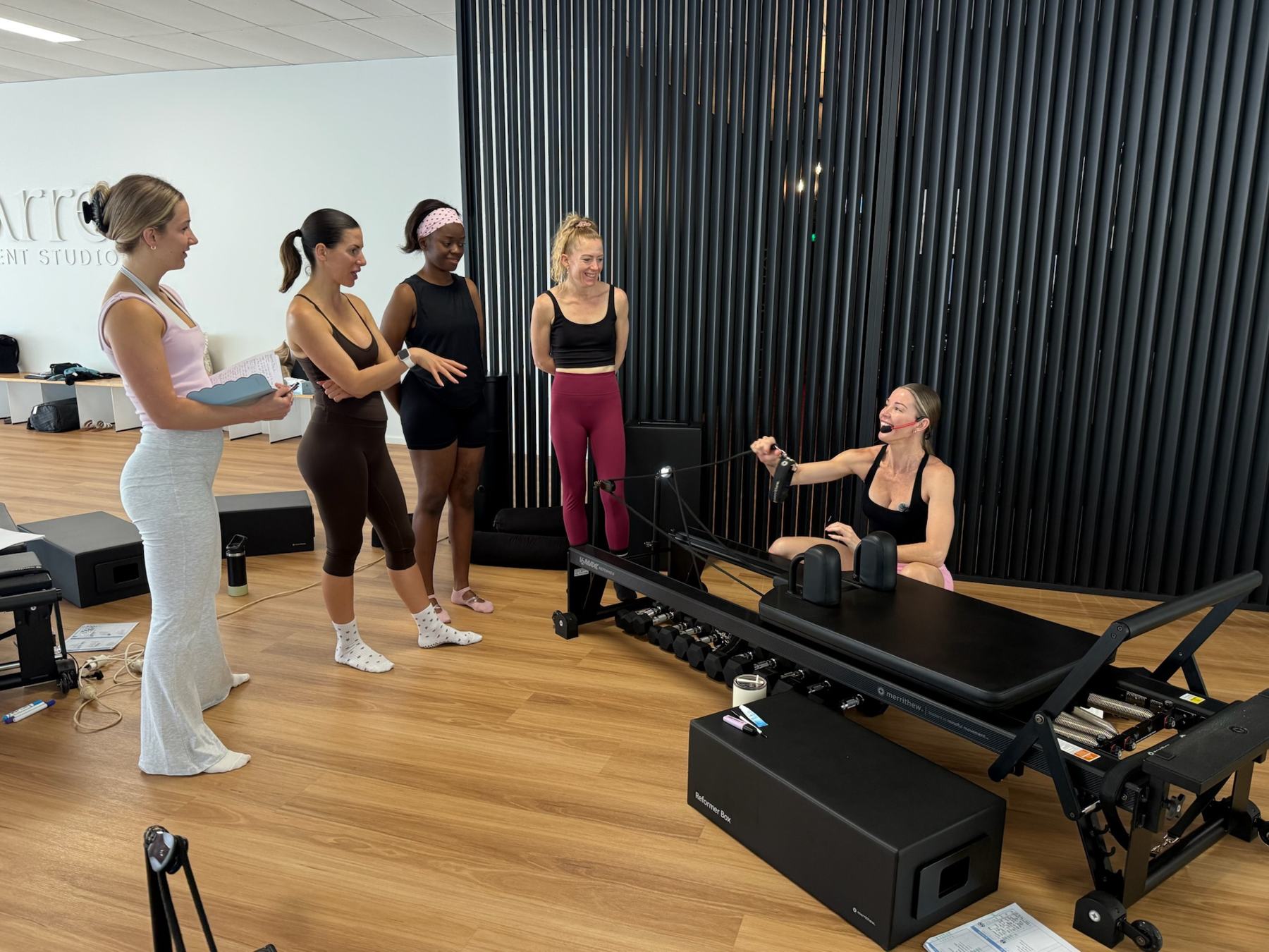 Students and trainer working on Reformers during a Body Form Education intake