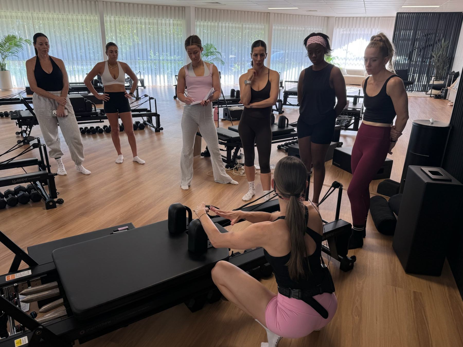 Students and trainer working on Reformers during a Body Form Education intake