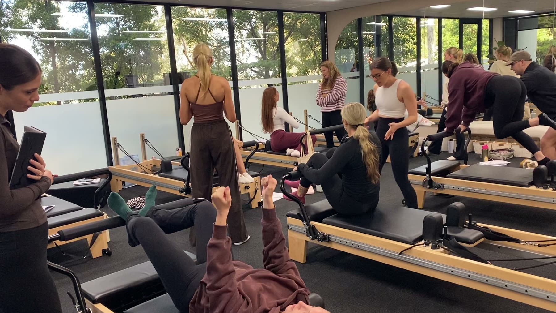 Students and trainer working on Reformers during a Body Form Education intake