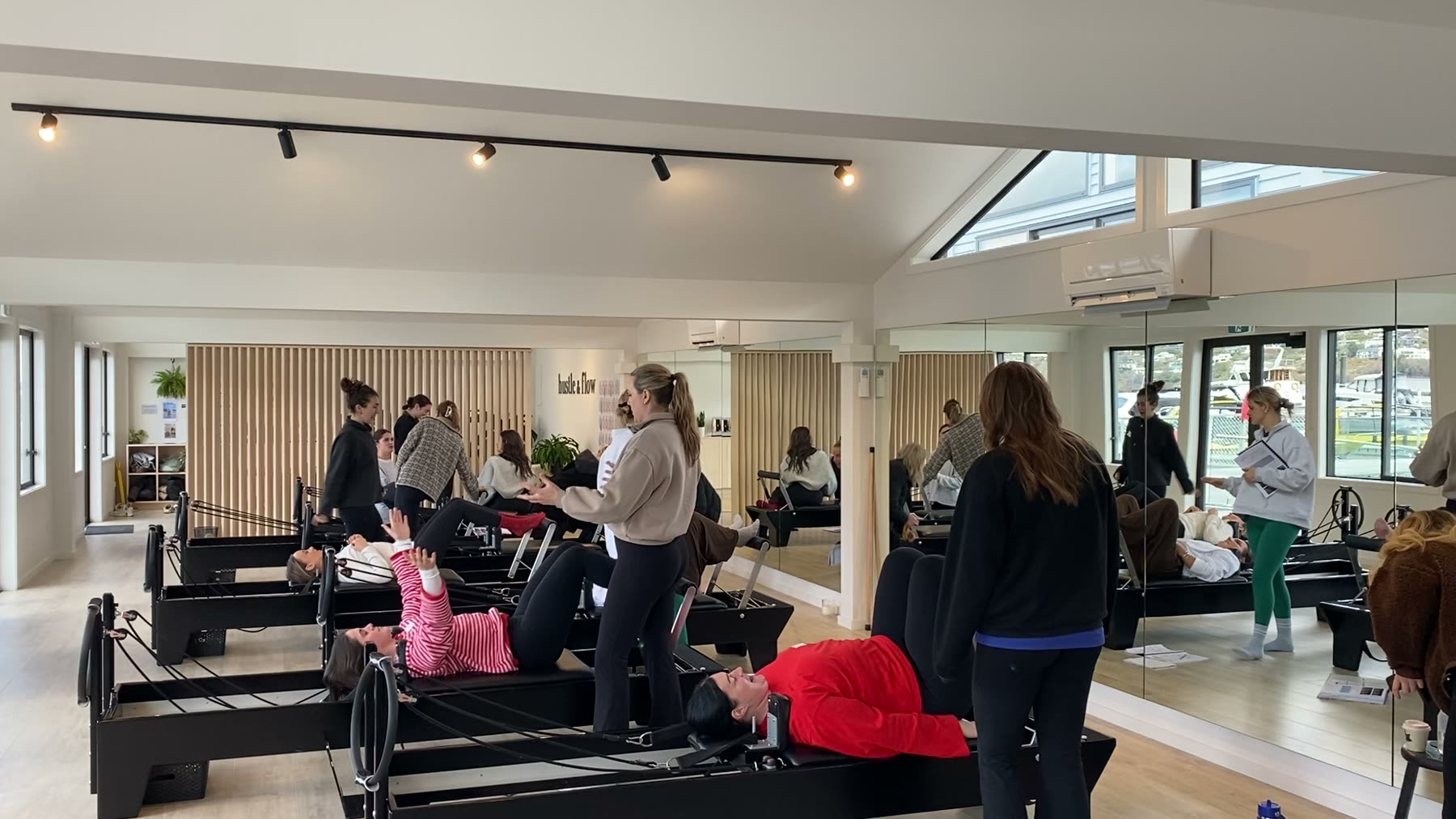 Students and trainer working on Reformers during a Body Form Education intake