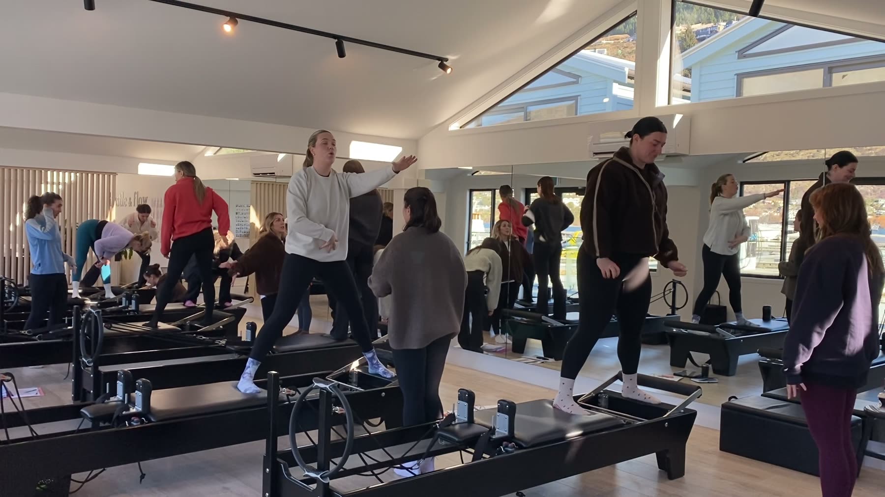 Students and trainer working on Reformers during a Body Form Education intake