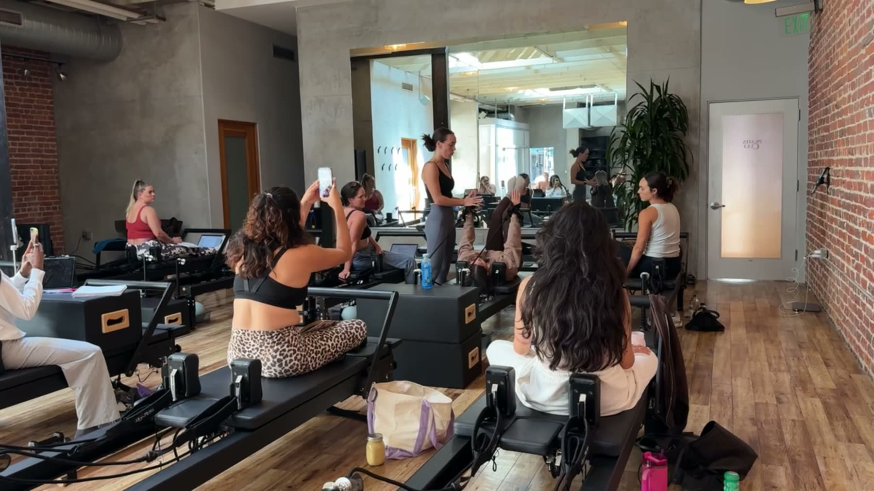 Students and trainer working on Reformers during a Body Form Education intake