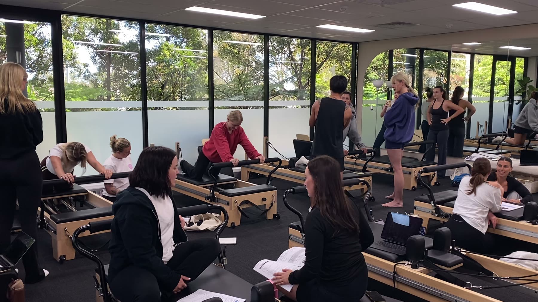 Instructor coaching a client on the Reformer