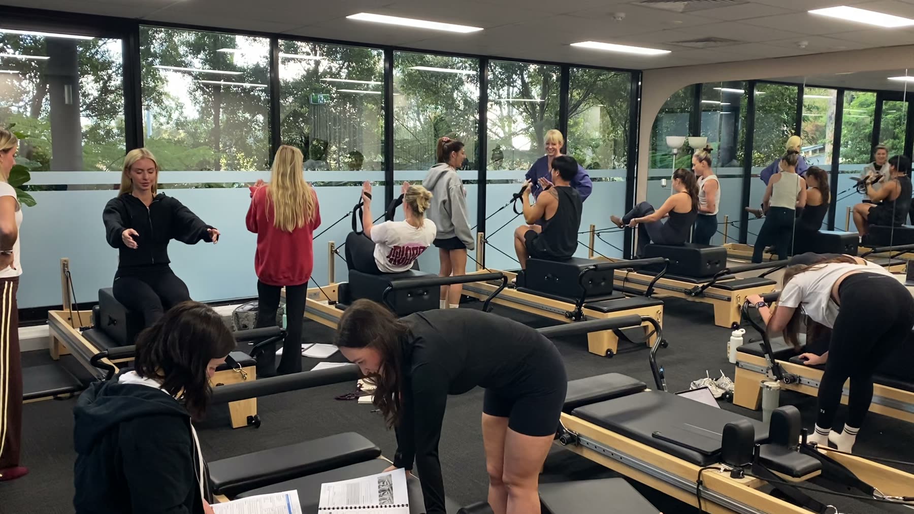 Students and trainer working on Reformers during a Body Form Education intake