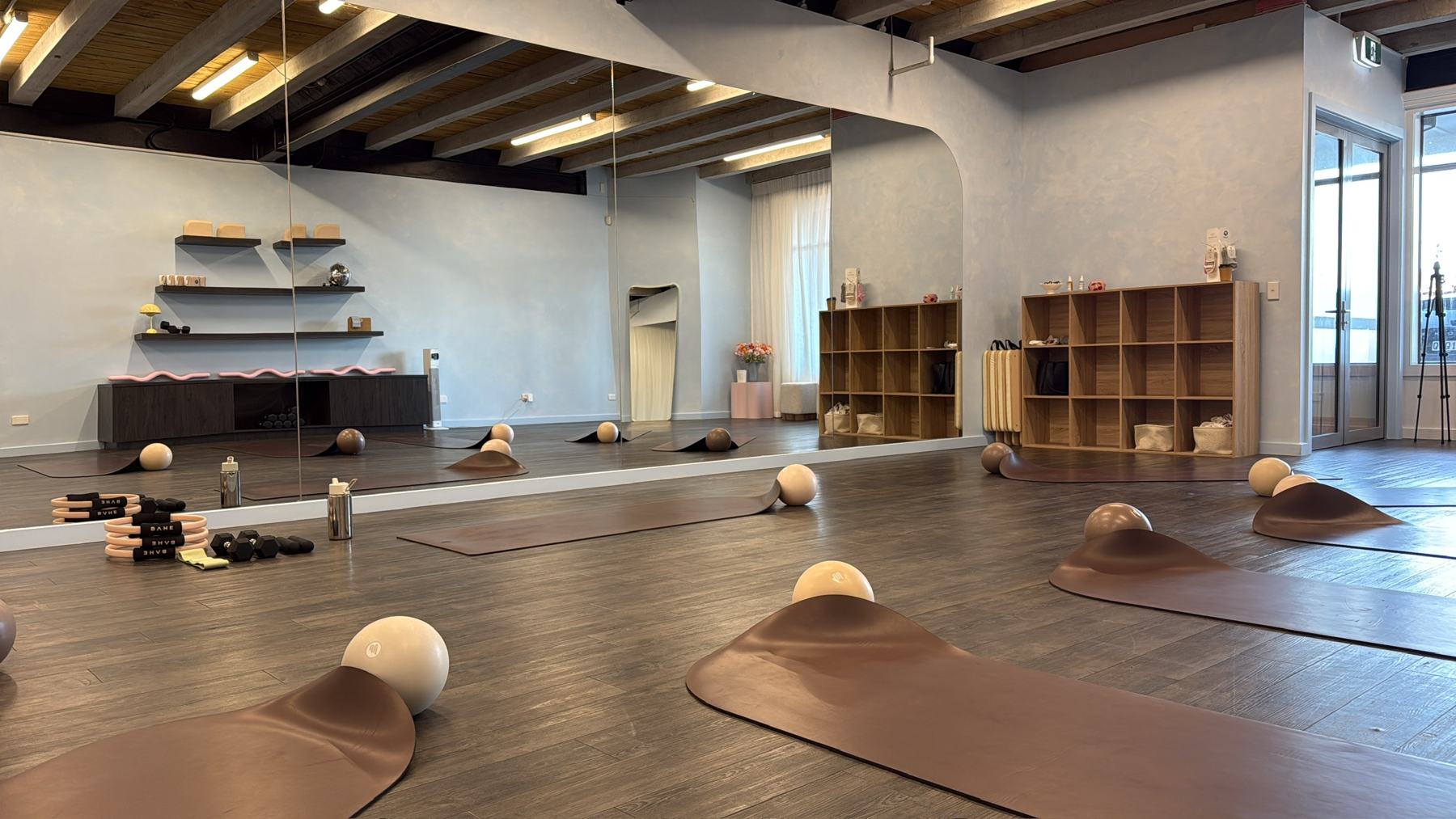 Instructor coaching a student on Pilates studio equipment at a Body Form Education intake