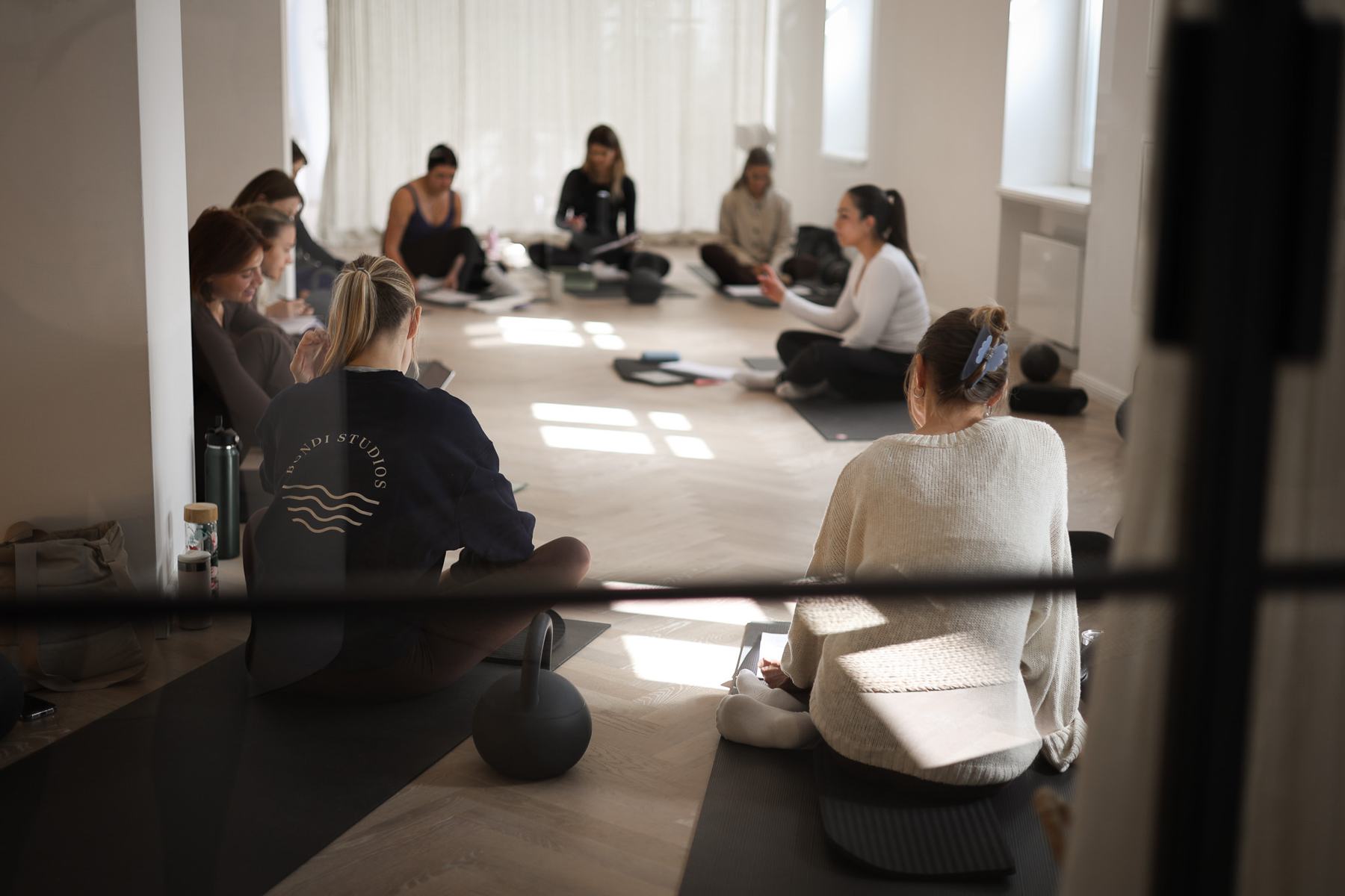 Instructor coaching a student on Pilates studio equipment at a Body Form Education intake